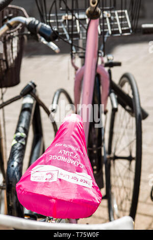 Bicycle seats with Race for Life covers by Cancer Research in Cambridge, England, UK. Stock Photo