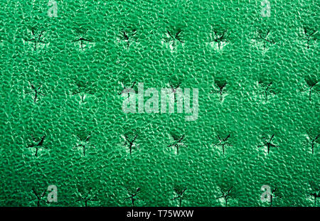 Green perforated leather texture background. Leather close up. Macro shot of shiny leather texture. Stock Photo