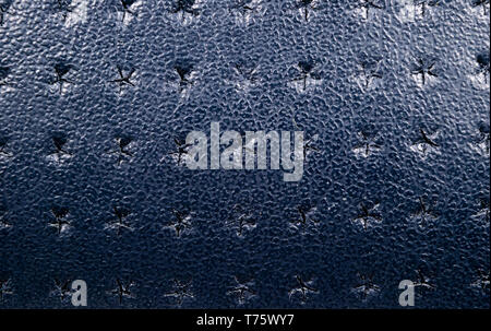 Blue perforated leather texture background. Leather close up. Macro shot of shiny leather texture. Stock Photo