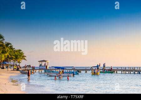 People enjoying a warm evening sunset at West Bay Roatan Honduras Stock Photo