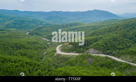 Serpentine Road Among Green Hills of Peak Caucasian Mountains, Russia Stock Photo