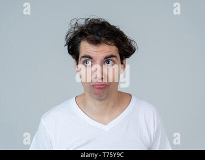 Thinking funny faces. Portrait of worried young man confused. Thoughtful male thinking in new ideas, creative ways to success, learning new languages  Stock Photo