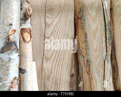 Wooden pillars and thick boards in the furniture workshop are ready to work joiner, soft focus Stock Photo