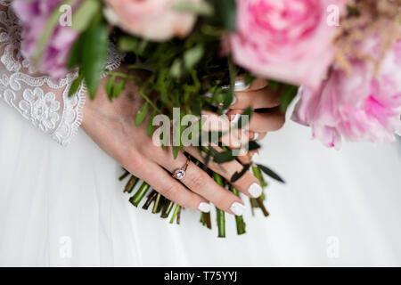 Wedding bouquet in the hands of the bride Stock Photo