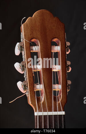Spanish guitar headstock classical on a black background Stock Photo