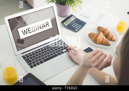 Webinar online, internet education, e-learning concept. Woman watching e-learning content on laptop Stock Photo