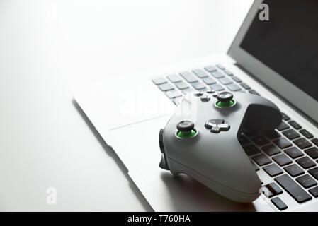 Wireless game pad controller on laptop keyboard Stock Photo