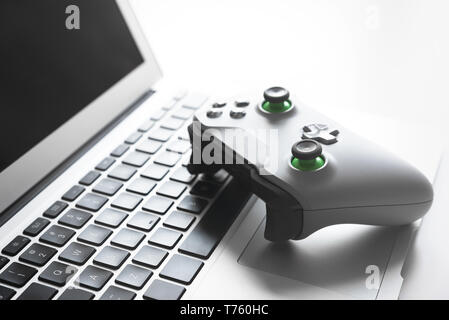 Wireless game pad controller on laptop keyboard Stock Photo