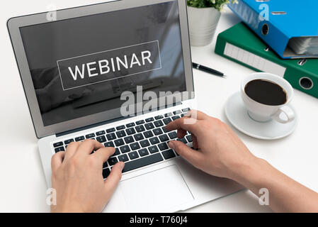 Webinar online, internet education, e-learning concept. Man typing on laptop keyboard. Stock Photo