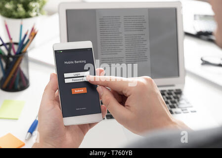 Man using mobile banking application on smartphone Stock Photo