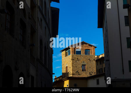 The Ponte Vecchio, a medieval stone closed-spandrel segmental arch bridge over the Arno River, in Florence, Italy, noted for still having shops built  Stock Photo