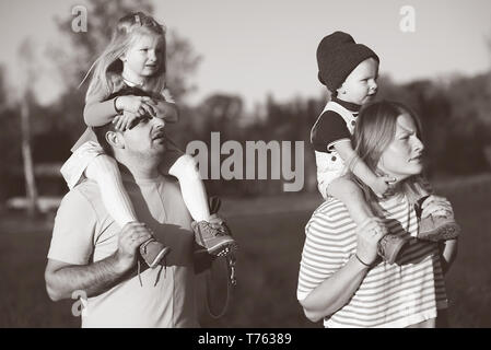 Happy family: mother, father, children son and daughter on sunset Stock Photo