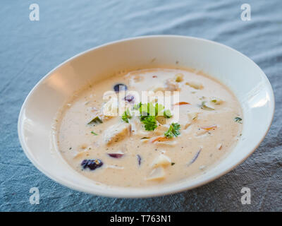 Delicious creamy salmon soup in black bowl with baguette - traditional ...