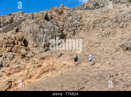 Couple hiking a simple trail to the tidal pools at Grand Fond in St Barts Stock Photo
