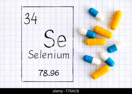 Handwriting chemical element Selenium Se with pills. Close-up. Stock Photo