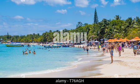 People enjoying the beach at West Bay in Roatan Honduras on a sunny April day. Stock Photo