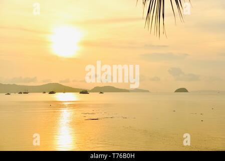 Yellow Sunrise Over the Andaman Sea Near Rawai Beach in Phuket Stock Photo