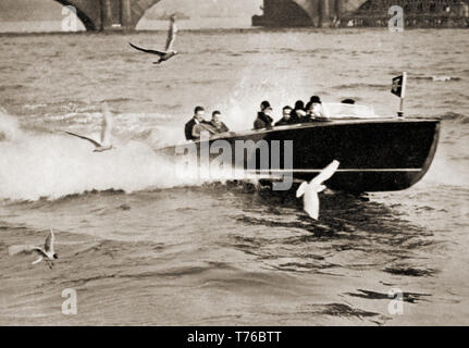 A photograph of one of the first high-class motorised water taxis to operate on the Thames at  London, England. Passengers are seen wearing fur lined collars and trilby hats. These boats took over from electric boats that had been used since the 1880s. Stock Photo