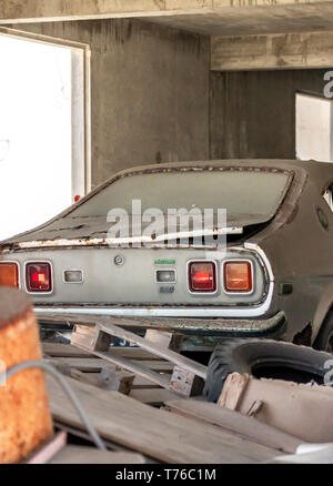 An old wrecked grey Mazada inside a ruined building in Gustavia St Barts Stock Photo