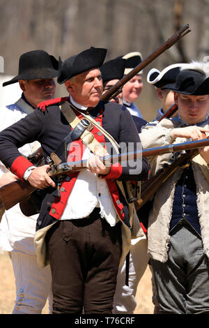 Reenactors of American Continental Army loading their muskets in Jockey Hollow Historical Park during annual Jockey Hollow Encampment.New Jersey.USA Stock Photo