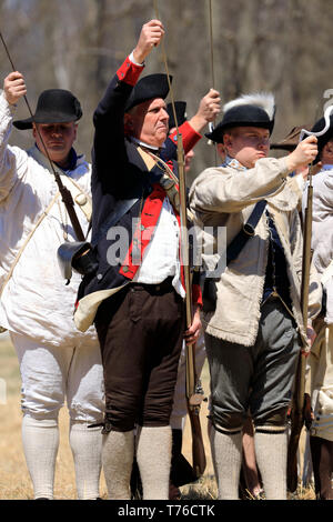 Reenactors of American Continental Army loading their muskets in Jockey Hollow Historical Park during annual Jockey Hollow Encampment.New Jersey.USA Stock Photo