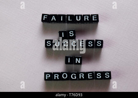 Failure is success in progress on wooden blocks. Motivation and inspiration concept Stock Photo