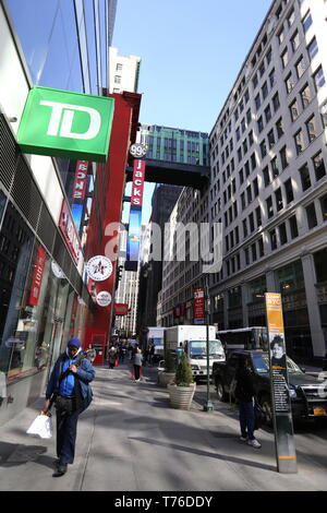 New York City, NY - March 12, 2017: Unidentified persons walking with shopping bags in Midtown Manhattan, NY Stock Photo