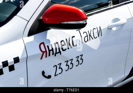 Samara, Russia - May 1, 2019: Modern car of Yandex Taxi company in the parking lot on city street closeup at sunny day Stock Photo