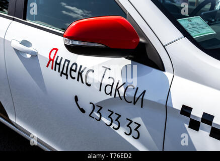 Samara, Russia - May 1, 2019: Modern car of Yandex Taxi company in the parking lot on city street closeup at sunny day Stock Photo