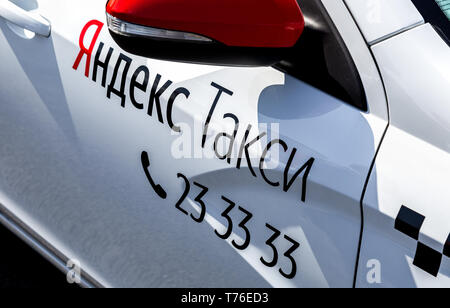 Samara, Russia - May 1, 2019: Modern car of Yandex Taxi company in the parking lot on city street closeup at sunny day Stock Photo