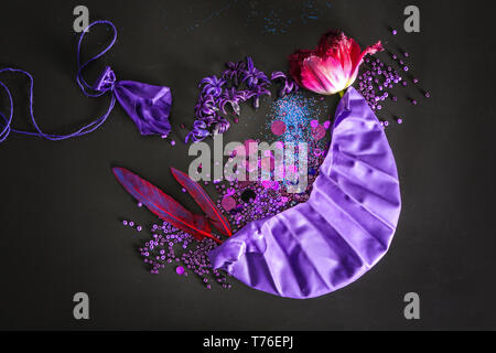 Composition with different items in purple colors on dark background Stock Photo