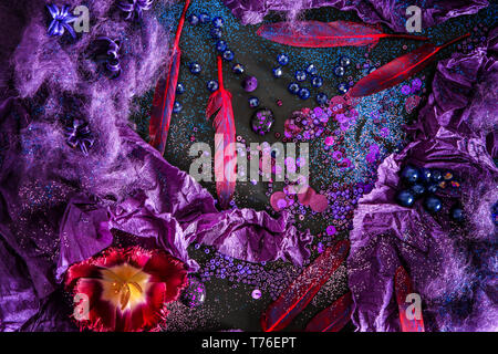 Composition with different items in purple colors on dark background Stock Photo