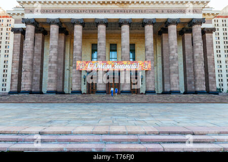 Two women walking up the stairs of the grand Moscow Lomonosov State University (MSU) main building entrance. Moscow, Russia Stock Photo