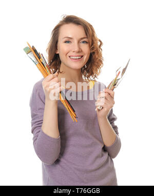 Female artist with paint tools on white background Stock Photo