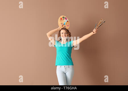 Female artist with palette and spatula on white background Stock Photo ...