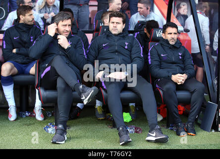 Tottenham Hotspur manager Mauricio Pochettino (centre), first team coach Jesus Perez (right) and Miguel D'Agostino in the dugout during the Premier League match at the Vitality Stadium, Bournemouth. Stock Photo