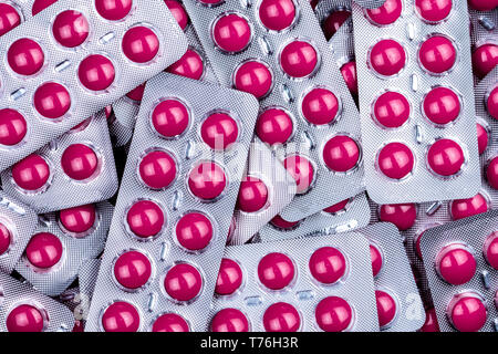 Pile of round pink tablets pill in blister pack. Pharmaceutical industry. Pharmacy products. Prescription drug. Painkiller medicine. Ibuprofen for Stock Photo