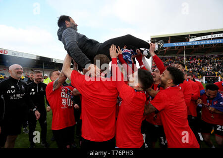 Lincoln City Manager Danny Cowley is thrown into the air as his team celebrate after the Sky Bet League Two match at Sincil Bank, Lincoln. Stock Photo