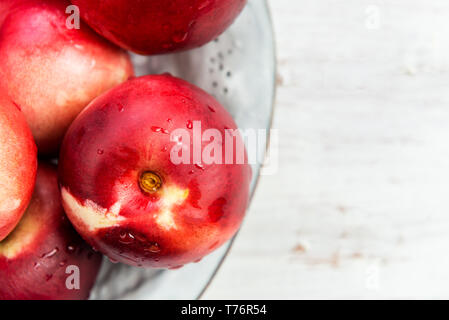 Fresh Nectarines in Rustic Ceramic Plate Stock Photo