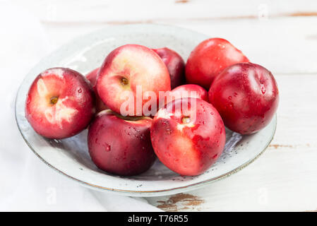 Fresh Nectarines in Rustic Ceramic Plate Stock Photo