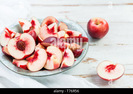 Fresh Nectarines Pieces in Rustic Ceramic Plate Stock Photo