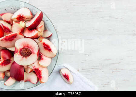 Fresh Nectarines Pieces in Rustic Ceramic Plate Stock Photo