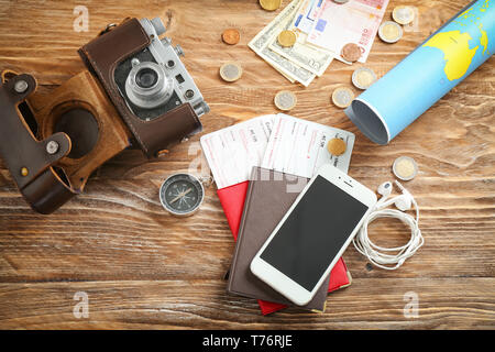 Composition with world map, passports and mobile phone on wooden table. Travel planning concept Stock Photo