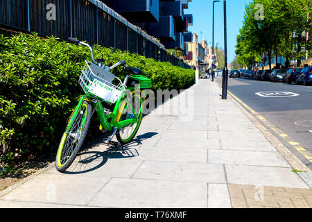 A dockless Lime-E rental electric bicycle standing on the street in East London, UK Stock Photo