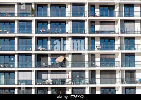 Glass facade of a modern apartment building with a lot of balconies seen in Hamburg, Germany Stock Photo