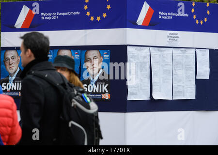 People seen walking past a political advert and information point ahead or the European Parliament elections scheduled for May 23rd to 26th 2019. Stock Photo