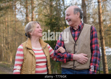 Happy elderly senior couple cycling in park Stock Photo