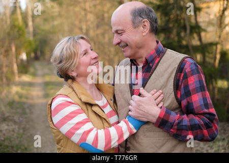 Happy elderly senior couple cycling in park Stock Photo