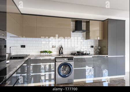 Spacious luxury well designed modern grey, beige and white kitchen with marble tiles floor Stock Photo