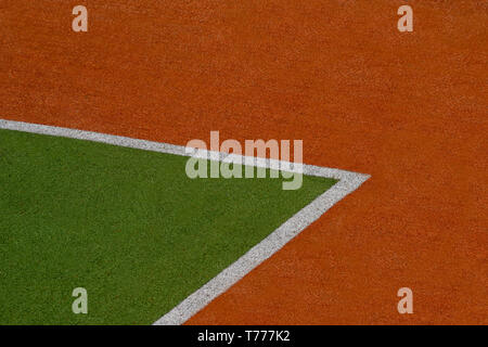Artificial green and brown turf texture background with white line marks Stock Photo